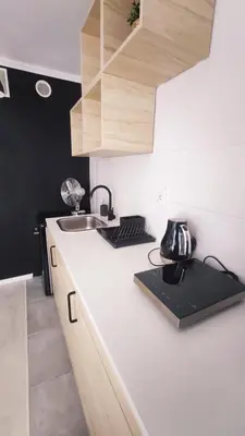 a kitchen with a sink and a counter top at Na Szaniec 17 by Homeprime in Kraków