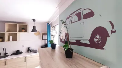 a kitchen with a table with a van on the wall at Na Szaniec 17 by Homeprime in Kraków