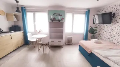 a small bedroom with a bed and a table and window at Na Szaniec 17 by Homeprime in Kraków