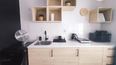 a kitchen counter with a sink and a fan at Na Szaniec 17 by Homeprime in Kraków