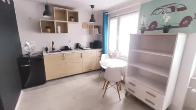 a kitchen with a small table and a refrigerator at Na Szaniec 17 by Homeprime in Kraków