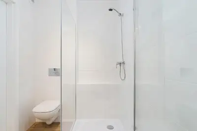 a bathroom with a glass shower with a toilet at Mieszczańska 10 by Homeprime in Kraków