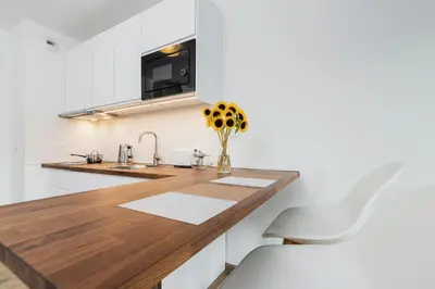 a kitchen with a wooden counter and a sink at Mieszczańska 10 by Homeprime in Kraków