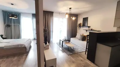 a bedroom with a bed and a living room at Wrocławska 53L by Homeprime in Kraków
