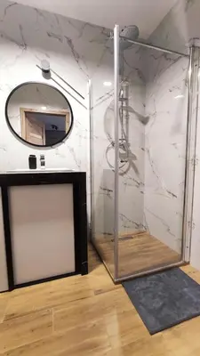 a bathroom with a shower with a mirror at Wrocławska 53L by Homeprime in Kraków