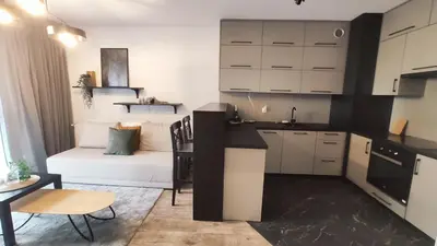 a small kitchen with a couch and a table at Wrocławska 53L by Homeprime in Kraków