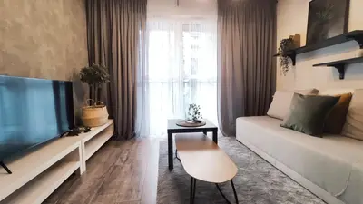 a living room with a couch and a tv at Wrocławska 53L by Homeprime in Kraków
