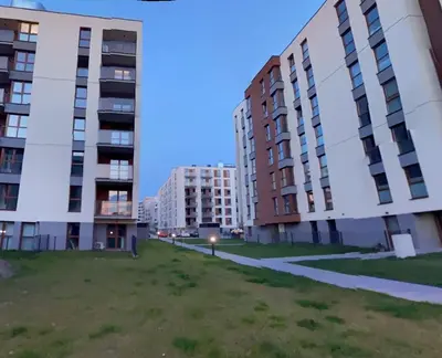 a grassy area between two tall buildings at Wrocławska 53L by Homeprime in Kraków