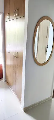 a mirror on a wall next to a door at Apartament 88 in Kraków