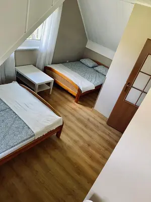 a small room with two beds and a window at Zielony Dom in Węglówka