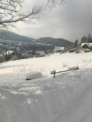 a snow covered yard with a snow covered road at Zielony Dom in Węglówka