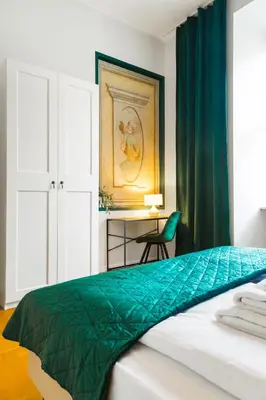 a bedroom with a bed and a desk with a chair at Glamorous Apartment in heart of Old Town in Kraków
