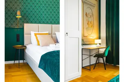 a bedroom with a bed and a green wall at Glamorous Apartment in heart of Old Town in Kraków