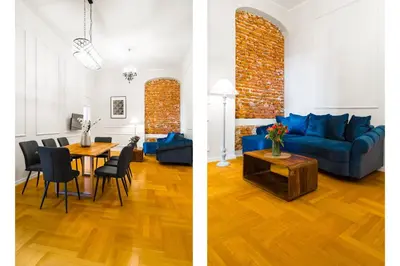 a living room and a dining room with a blue couch at Glamorous Apartment in heart of Old Town in Kraków