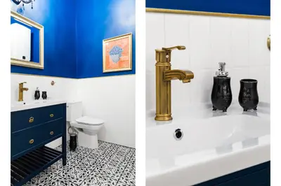 a bathroom with a sink and a gold faucet at Glamorous Apartment in heart of Old Town in Kraków