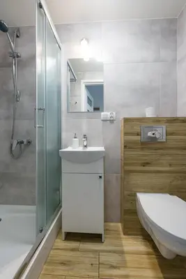 a bathroom with a sink and a shower and a toilet at Near the Royal Castle in Kraków