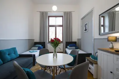 a living room with a couch and a table with chairs at Near the Royal Castle in Kraków