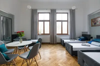 a living room with a couch and a table and chairs at Near the Royal Castle in Kraków