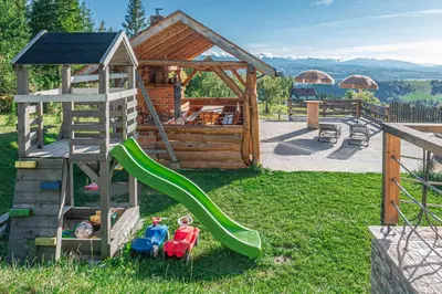a playground with a slide and a play house at Leśne Zacisze in Nowy Targ