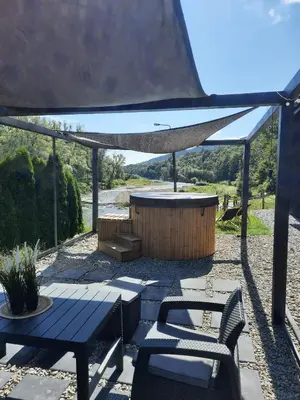 a patio with a table and a bench and a canopy at Stodoła Nad Skawą in Sucha Beskidzka