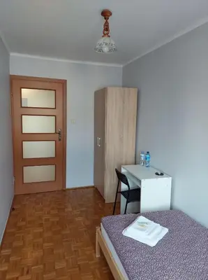 a bedroom with a mirror and a bed in a room at Mieszkanie na Mickiewicza 7 in Olkusz