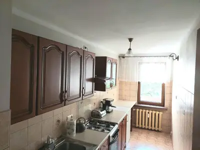 a living room with a couch and a sliding door at Mieszkanie na Mickiewicza 7 in Olkusz