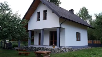 a white house with a black roof at Domek w Zawoi Chwilo Trwaj in Zawoja