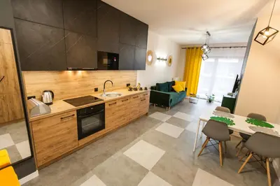 a kitchen and living room with a table and chairs at Vintage Rakowicka Apartment in Kraków