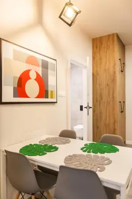 a dining room with a table and chairs at Vintage Rakowicka Apartment in Kraków