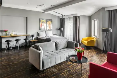 a living room with a couch and a bed at Premium Penthouse Apartment in Kraków