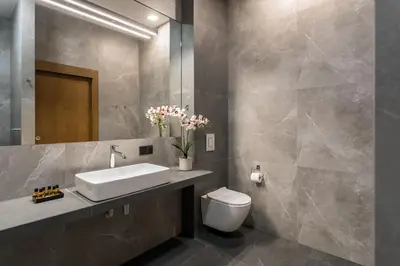 a bathroom with a sink and a toilet at Premium Penthouse Apartment in Kraków