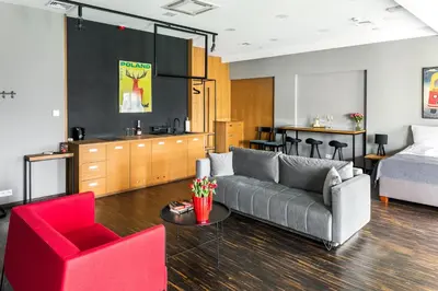 a living room with a couch and a bed at Premium Penthouse Apartment in Kraków