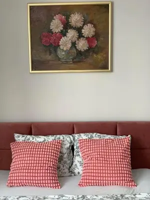 a picture of a vase of flowers on a wall at Kotlarska Apartments in Kraków