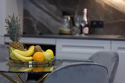 a bowl of fruit on a table in a kitchen at Kotlarska Apartments in Kraków
