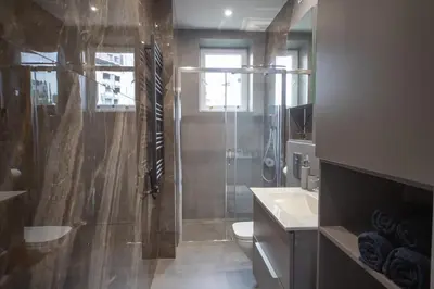 a bathroom with a shower and a toilet and a sink at Kotlarska Apartments in Kraków