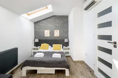 a bedroom with a bed with yellow pillows at Modern apartment in the very central location 18 in Kraków