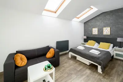 a living room with a couch and a bed at Modern apartment in the very central location 18 in Kraków