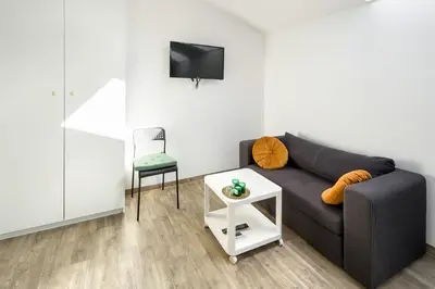 a living room with a couch and a chair at Modern apartment in the very central location 18 in Kraków