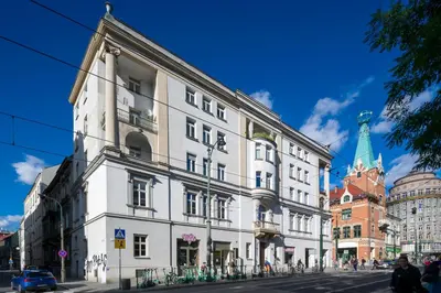 a large white building on a city street at Modern apartment in the very central location 18 in Kraków