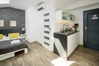 a small room with a bed and a sink at Modern apartment in the very central location 18 in Kraków