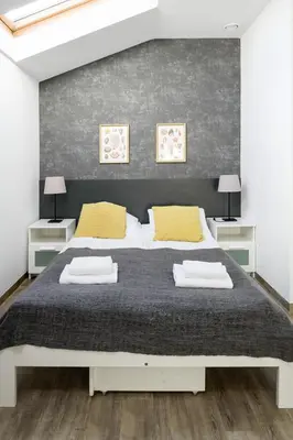 a bedroom with a large bed with yellow pillows at Modern apartment in the very central location 18 in Kraków