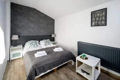 a bedroom with a bed and a white table at Modern aparment in the very central location 19 in Kraków