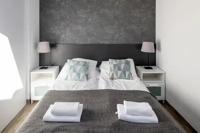 a bedroom with a large bed with two night stands at Modern aparment in the very central location 19 in Kraków