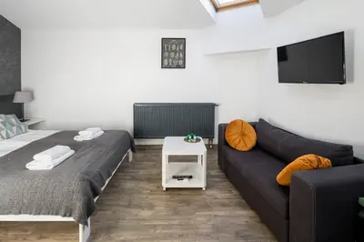 a living room with two beds and a couch at Modern aparment in the very central location 19 in Kraków