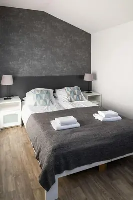 a bedroom with a large bed with two pillows on it at Modern aparment in the very central location 19 in Kraków