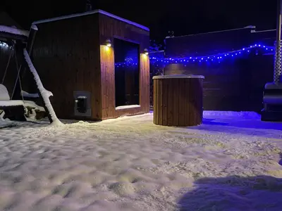 a building covered in snow with blue lights at MiiG Residence Jacuzzi & Sauna Zator Oświęcim in Oświęcim