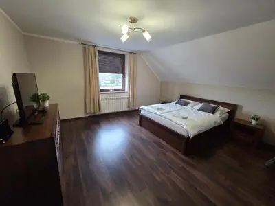 a hallway with stairs with two people and a dog at MiiG Residence Jacuzzi & Sauna Zator Oświęcim in Oświęcim
