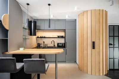 a kitchen with a wooden table and chairs at NovaNest Apartments - Kalwaryjska - by Upstairs in Kraków