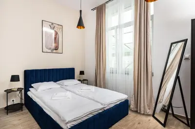 a bedroom with a blue bed with a window at NovaNest Apartments - Kalwaryjska - by Upstairs in Kraków
