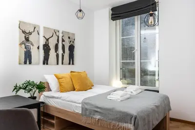 a bedroom with a bed and a window at NovaNest Apartments - Kalwaryjska - by Upstairs in Kraków